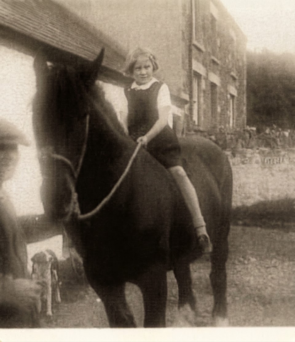 Historic image of a young girl riding to school on horseback at Henbont Holidays, highlighting Carmarthenshire farm heritage, traditional Welsh rural life, horse‑powered travel, and the authentic countryside history that shapes this off‑grid Welsh cabin stay