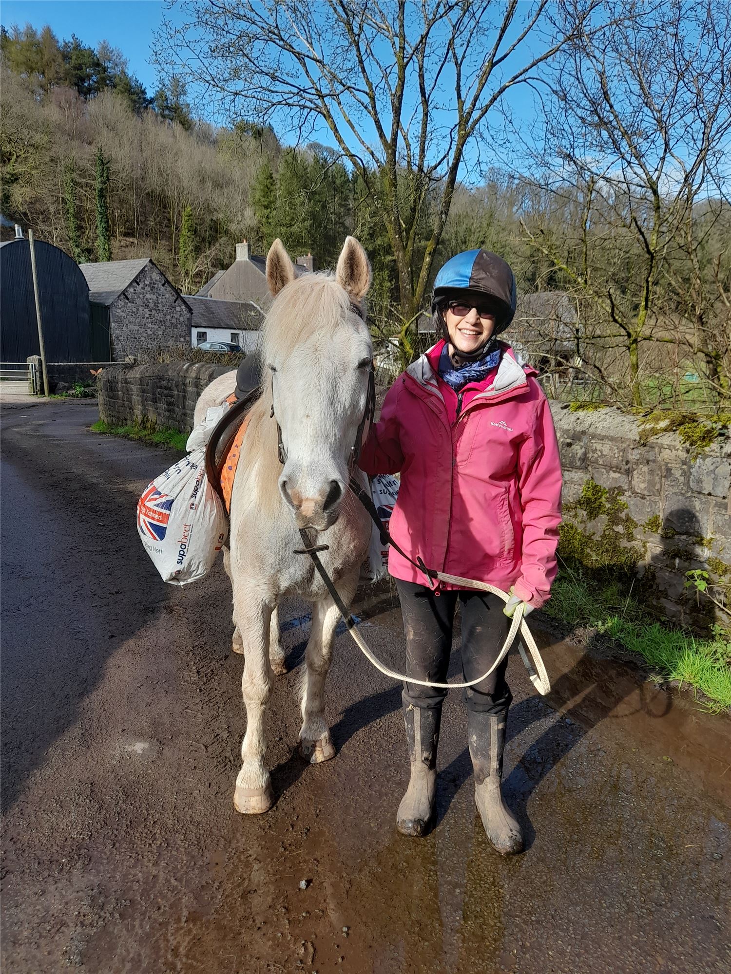 Carrying feed to the sheep on a pony at Henbont, showing traditional Welsh farm life and Carmarthenshire rural heritage.